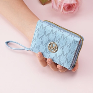 Close-up of light blue trifold wallet with M-pattern print and gold logo detailing