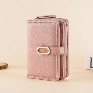 Detail view of pink lychee textured leather wallet with card slots and golden ring buckle