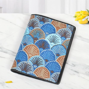 Close-up of woven shell pattern fabric and leather edge on short wallet for women