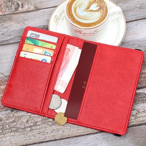 Detail view of red leather RFID passport wallet showing interior card slots and cash pocket
