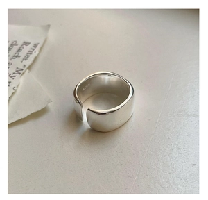 Close-up of polished S925 sterling silver wide band ring with hallmarked interior
