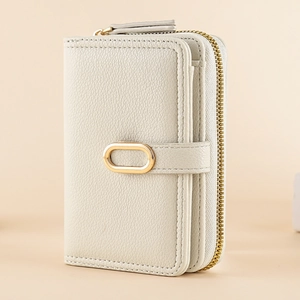 Detail of lychee pattern leather wallet with golden zipper and metal ring buckle
