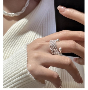 Detail of S925 sterling silver multi-layer chain ring on a model with knitwear