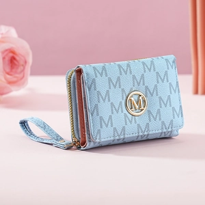 Detail of light blue tri-fold wallet with M-letter pattern and golden logo emblem