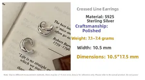 Detail view of polished S925 sterling silver triple-layer cross ear cuff on a book