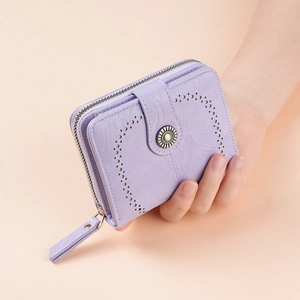 Detail of lilac wax leather wallet with heart-shaped cutouts and vintage metal button