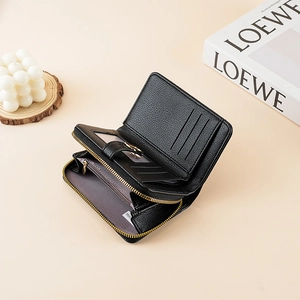 Close-up of litchi texture wallet showing multiple card slots and zipper pocket