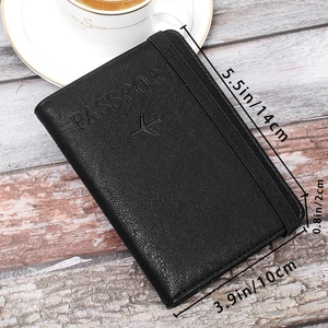 Close-up of black litchi pattern leather passport wallet with elastic band and embossed logo