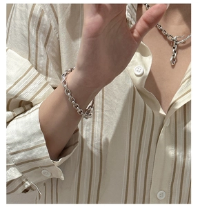 Detailed close-up of heavy chunky silver chain bracelet with vintage textured metal links