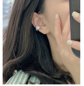 Close-up of minimalist S925 sterling silver triple-layer ear cuff on a model's ear