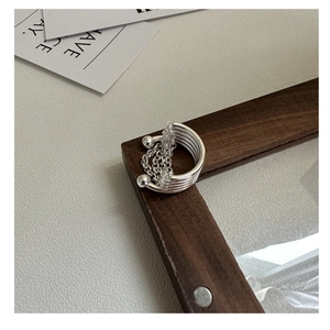 Detail of S925 sterling silver multi-layer chain ring on wood frame background