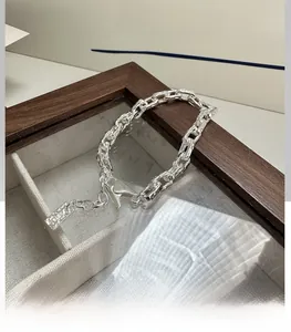 Detailed view of S925 sterling silver paperclip bracelet with hammered texture finish