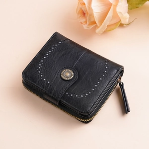 Close-up of black oil wax leather wallet with laser-cut hollow patterns and metal buckle