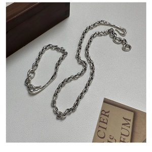 Detail of S925 sterling silver chain set with polished links and irregular clasp