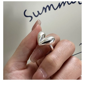 Macro shot of polished S925 sterling silver heart ring showing the inner metal hallmark