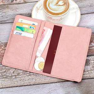 Detail view of pink leather passport wallet with RFID card slots and travel organizer