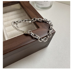 Close-up of S925 sterling silver stamp on vintage chain bracelet with toggle clasp