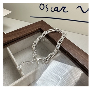 Detailed macro view of S925 sterling silver paperclip bracelet with hammer textured finish
