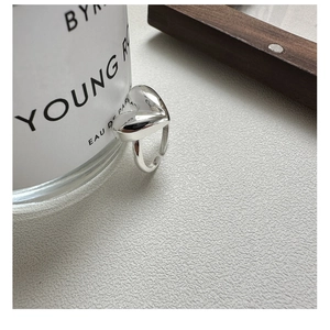 Close-up of polished S925 sterling silver heart-shaped ring with adjustable open band