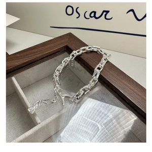 Detailed macro shot of S925 sterling silver paperclip chain bracelet with lobster clasp