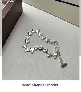 Detailed close-up of a S925 sterling silver heart-linked bracelet with a small diamond accent