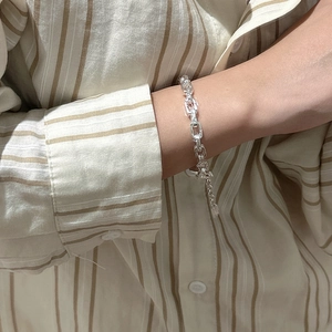 S925 sterling silver paperclip link chain bracelet with adjustable tail on a female wrist