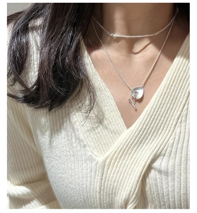 Detail of silver S925 sterling silver layered necklace with OT buckle on a model