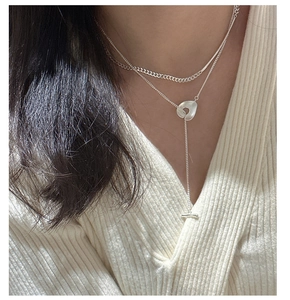 Close-up of S925 sterling silver layered necklace with OT buckle and geometric pendant