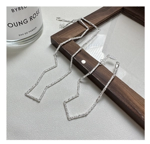 Macro shot of S925 sterling silver textured bar link bracelet on dark wood background