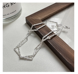 Macro shot of S925 sterling silver necklace with organic texture links and lobster clasp