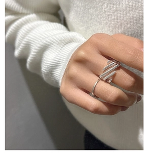 Detail shot of a minimalist S925 sterling silver layered ring with diagonal texture on hand