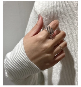 Close-up of S925 sterling silver ring with cross twill design worn on finger