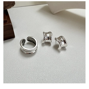 Detailed view of S925 sterling silver curved ring and ear cuffs with S925 hallmark