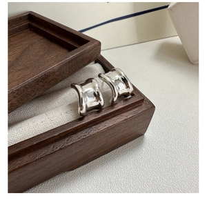 Polished S925 sterling silver chunky C-shaped hoop earrings in a wooden jewelry box