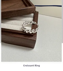Macro detail of S925 sterling silver croissant ring showing the hallmark engraving