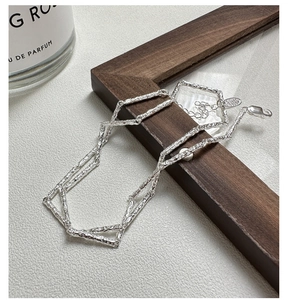 Macro view of S925 silver necklace featuring irregular texture links and lobster clasp