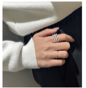 Detail of S925 sterling silver layered hollow and minimalist thin ring set on model