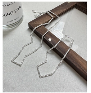 Detail view of S925 sterling silver hammered texture necklace on elegant leather background