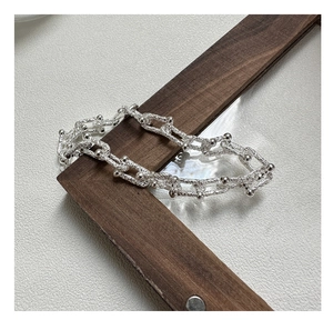 Detail of S925 sterling silver U-shaped link bracelet with textured patterns and metal beads