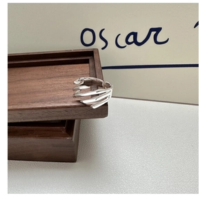 Close-up of S925 sterling silver ring with unique criss-cross texture and open adjustable band