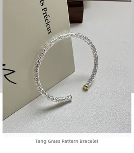 Detail of S925 silver cuff bracelet featuring intricate vintage scroll engravings and gold accents