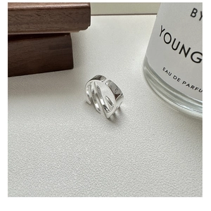 Detailed view of polished S925 sterling silver multilayer irregular open ring texture