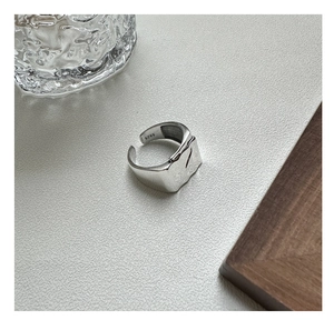 Macro view of S925 sterling silver ring featuring unique wavy pleated texture detail