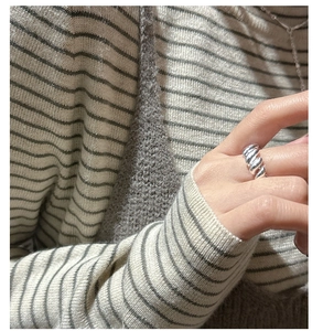 Macro shot of S925 sterling silver croissant ring on hand with modern chic styling