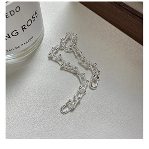 Detailed close-up of S925 sterling silver industrial style U-shaped link chain bracelet