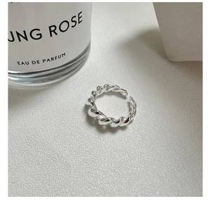 Detailed view of S925 sterling silver twisted croissant ring on textured background