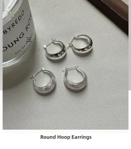 Detailed view of S925 sterling silver hoop earrings with polished and brushed textures