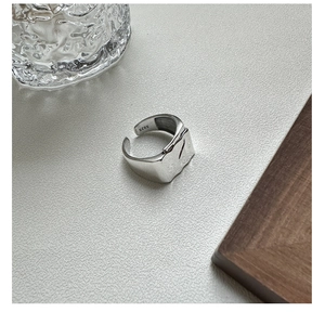 Detail view of S925 sterling silver ring with irregular hammered texture and hallmark