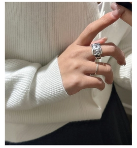 Close-up of S925 sterling silver belt buckle ring set on hand with minimalist band