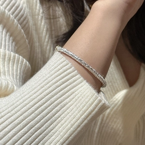 S925 sterling silver bangle featuring intricate vintage floral engraving worn on wrist